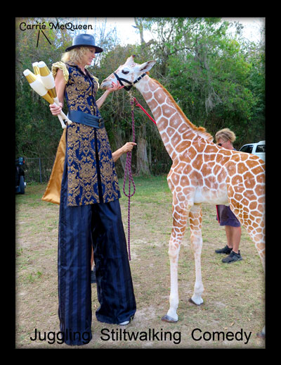 Carrie McQueen, stilt walker, looking a giraffe right in the eye.